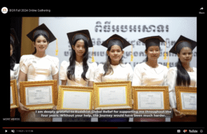 Four graduates smile proudly in their caps and gowns at a ceremony.